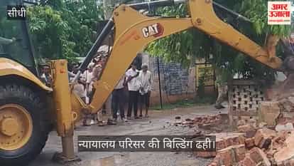Dilapidated wall collapses on people sheltering from heavy rain; two dead, two critically injured.