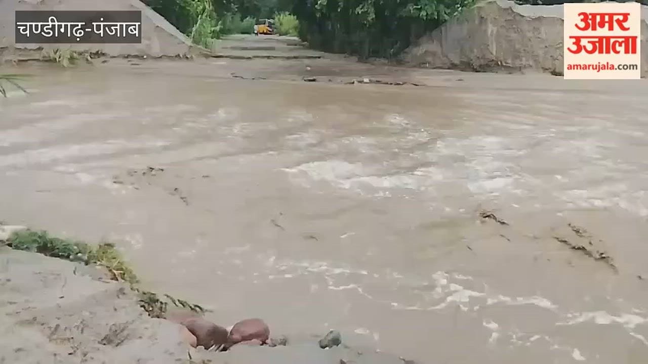 School bus gets stuck in mud after water flows into the seasonal drain.