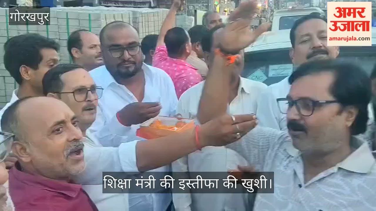 Congress members feeding each other sweets to celebrate the Education Minister's resignation.