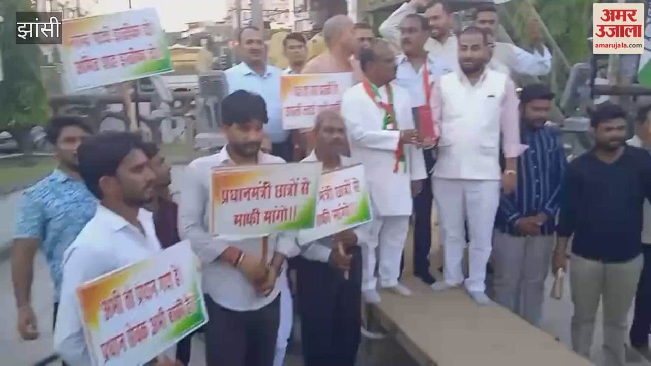 Congress holds victory procession over Education Minister's resignation; celebrates by distributing sweets.