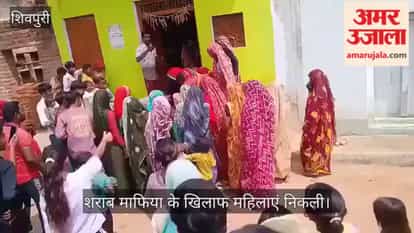 Women attack liquor mafia; illicit liquor dumped on the road.