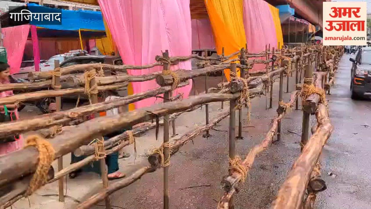 People passing under poles erected in front of district hospital in Ghaziabad