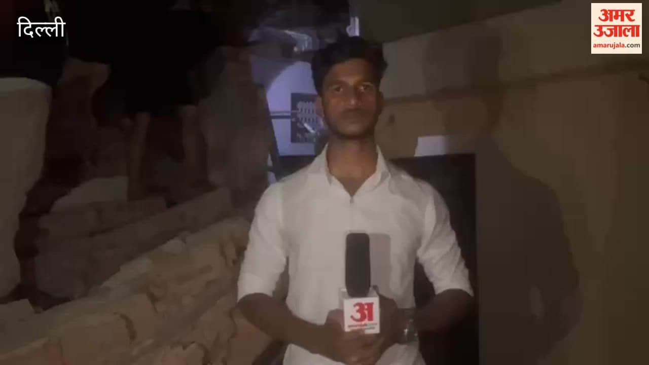 People are stranded on rooftops after a building collapsed in the Devra Ward of Ballimaran Delhi