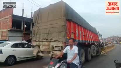 Cement-laden truck climbs onto the divider.