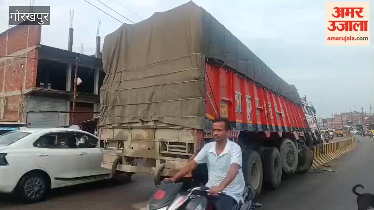 Cement-laden truck climbs onto the divider.
