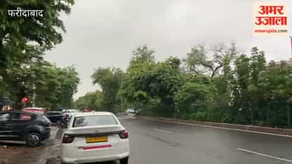 City residents get relief from the heat following rain; dark clouds gather in the sky.
