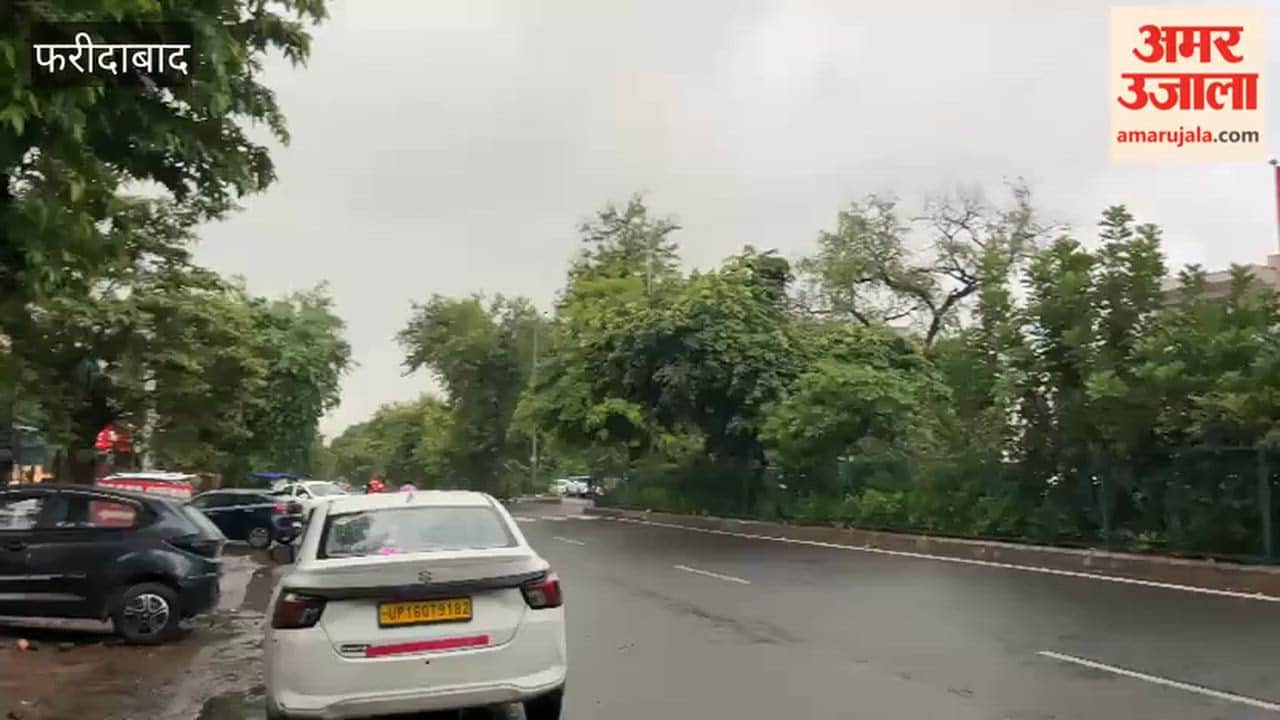 City residents get relief from the heat following rain; dark clouds gather in the sky.