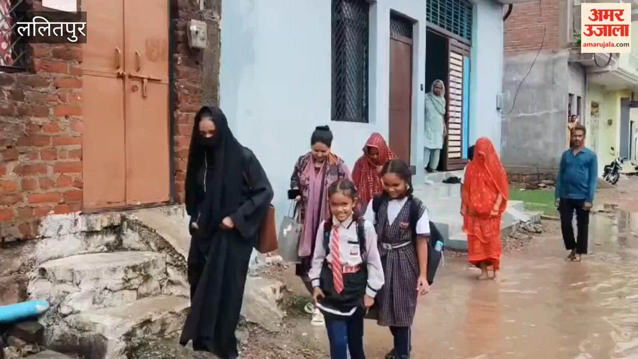 Road not built despite assurances; people in Siddhanpura forced to wade through mud.