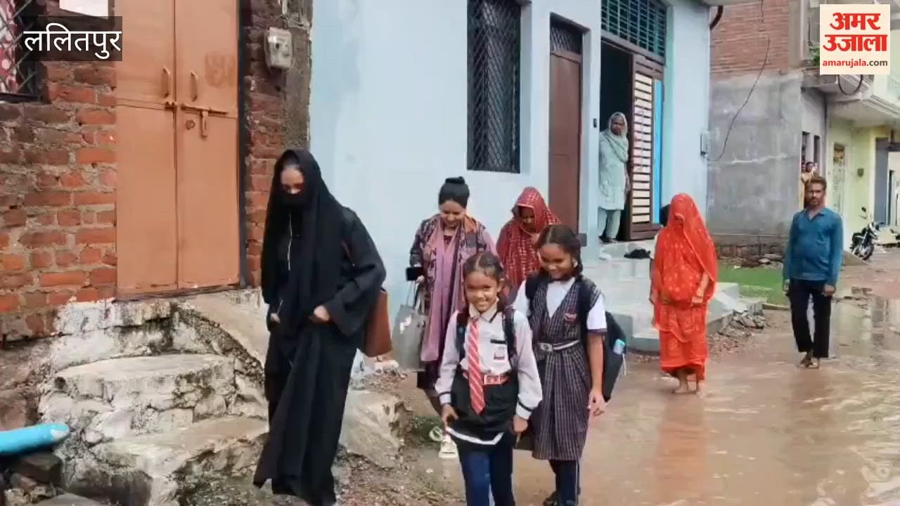 Road not built despite assurances; people in Siddhanpura forced to wade through mud.