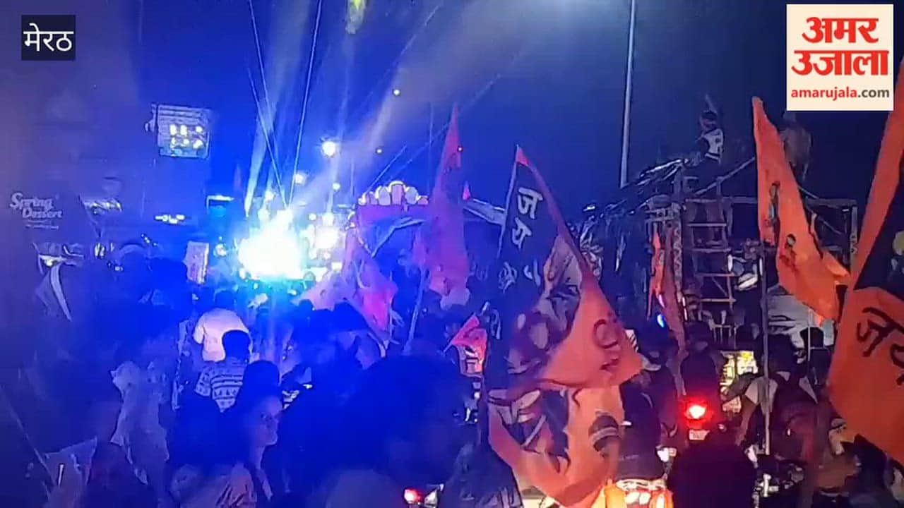 Meerut: Kanwariyas march along the highway with a DJ; crowds gather to watch.