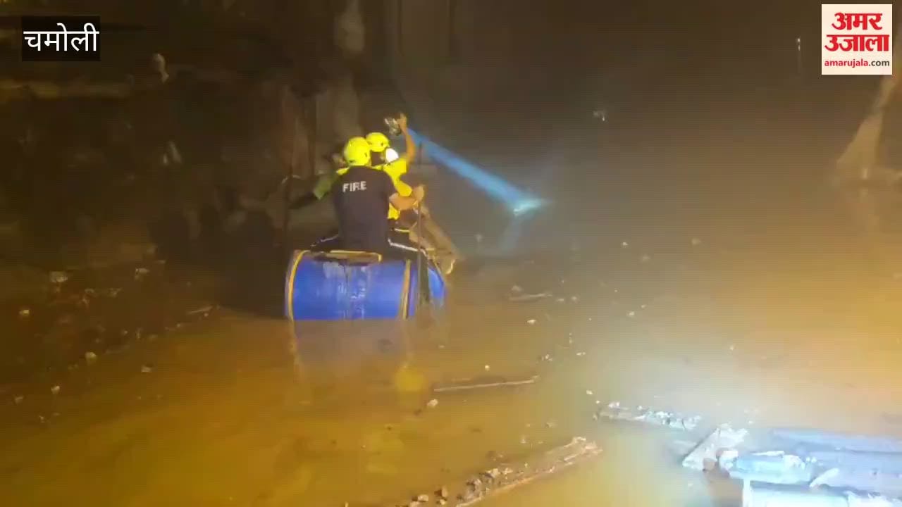 Chamoli tunnel incident; personnel are carrying out rescue operations using drums in a tunnel filled with debris and water