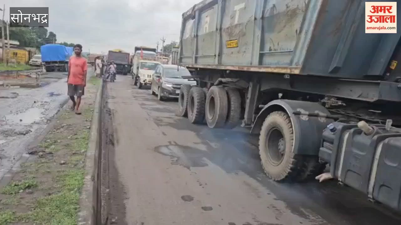 Traffic jam caused by vehicles getting stuck in potholes; people struggled with the congestion all day