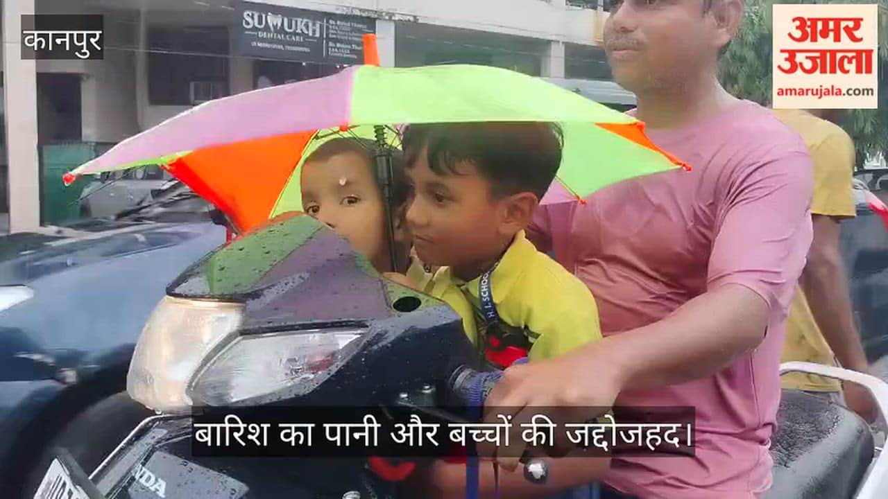 Children returning from school amidst rain in Kanpur Shastri Nagar