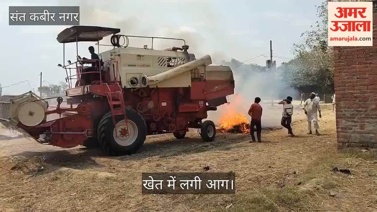 Fire breaks out in wheat stubble; combine harvester also engulfed.