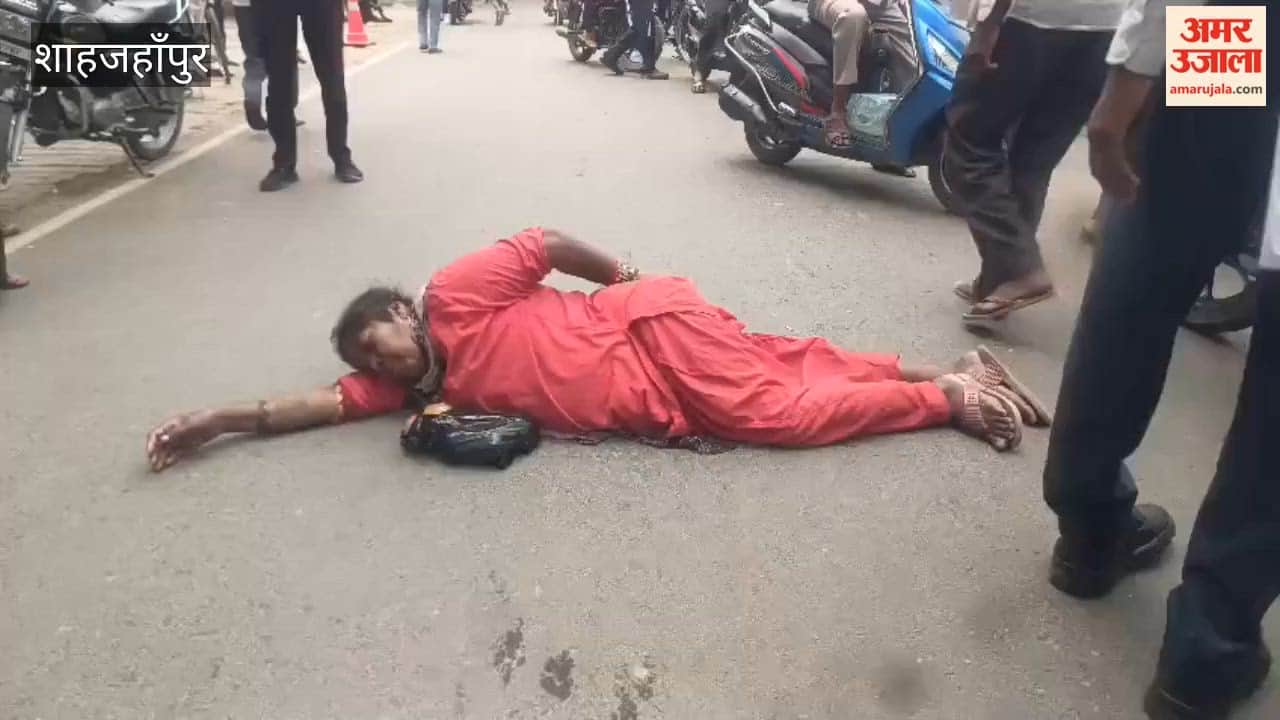 Woman Lies on Road Outside Collectorate Gate in Shahjahanpur
