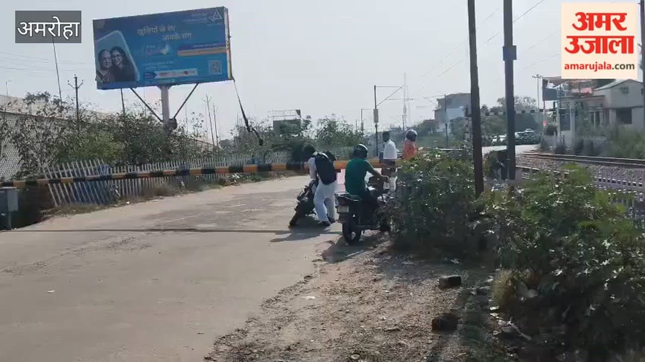 As the goods train continued to pass, people remained occupied with trying to maneuver their bikes through the closed railway gate