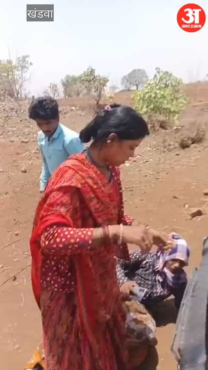 Women lay down in front forest vehicle to free encroachers