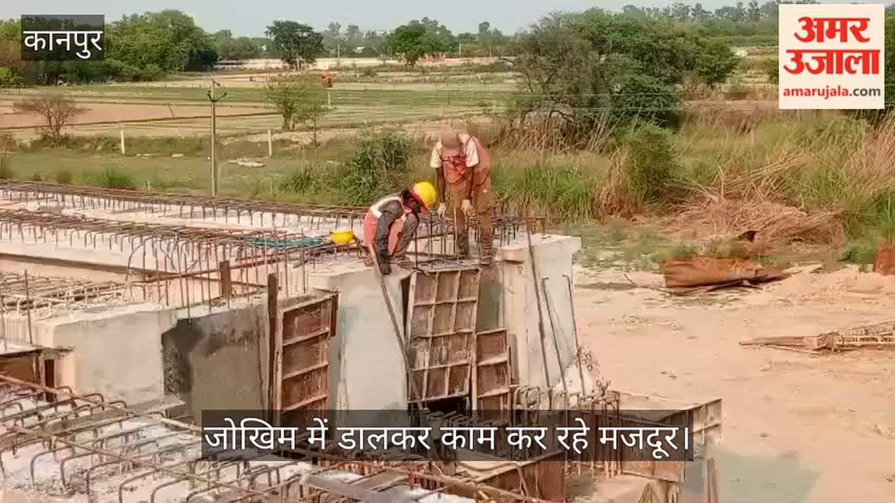 Workers Seen Without Safety Belts at Noon River Bridge Construction Site
