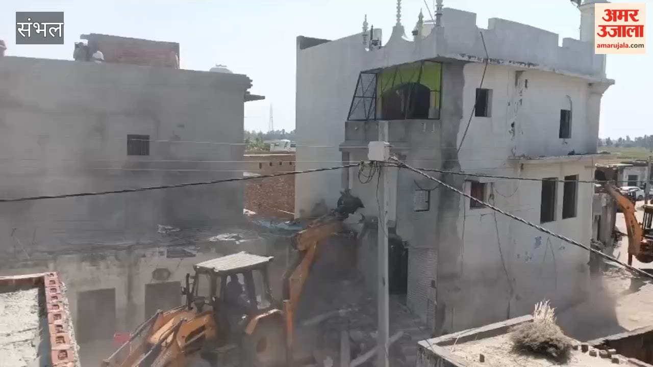 Mosque built on government graveyard land demolished by bulldozer; village resembled a garrison