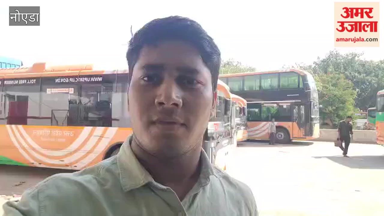 More than twenty buses are parked for charging at Noida Morna bus depot