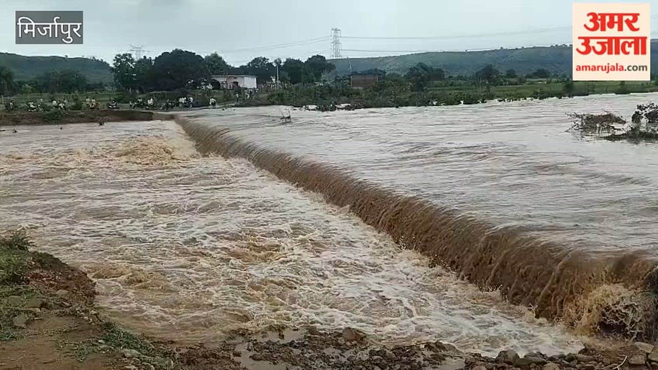 Sapahara River in spate water flows over road causing queue of vehicles