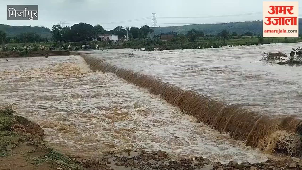 Sapahara River in spate water flows over road causing queue of vehicles