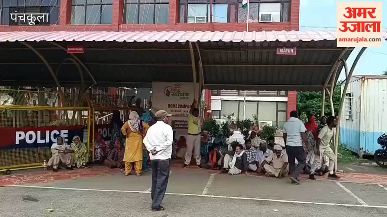 Sanitation workers stage a protest at the municipal corporation office gate in Panchkula.
