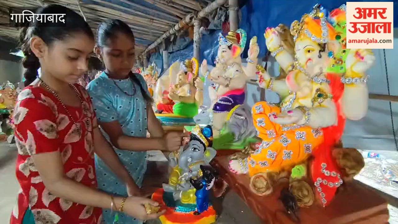 Artists Mamata and Karishma putting finishing touches on idol of Lord Ganesha