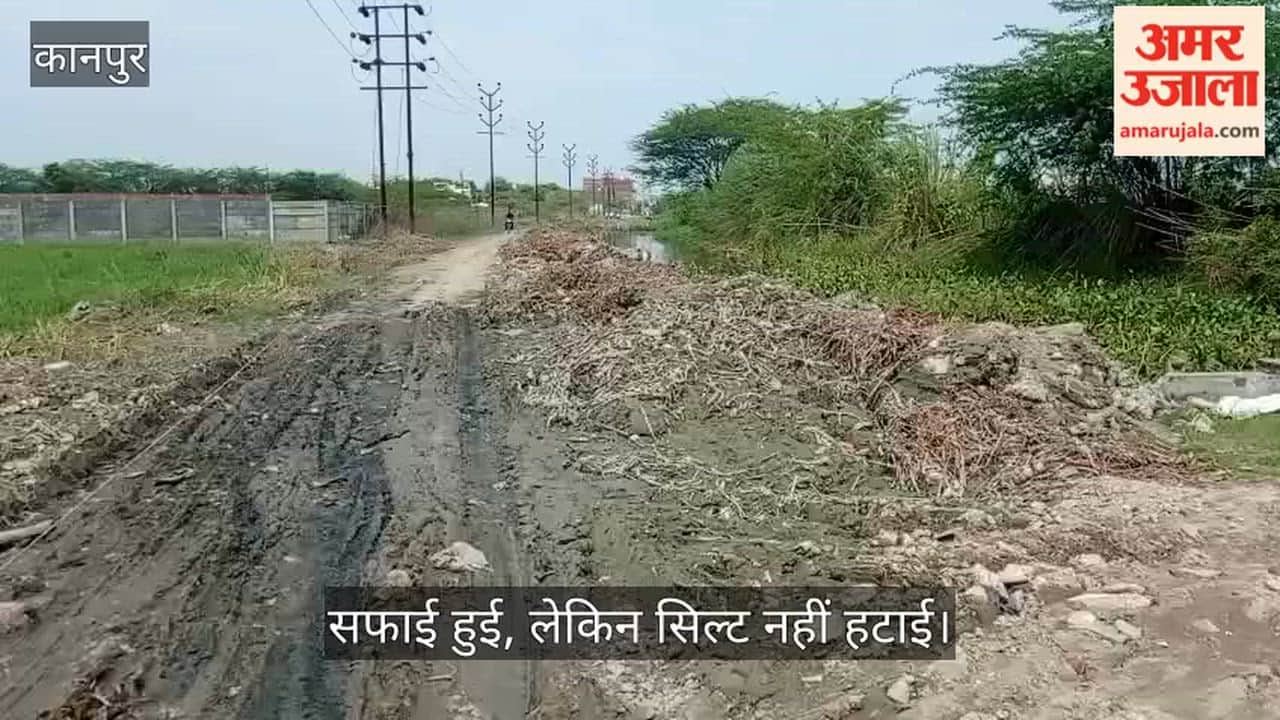 Silt from drain cleaning dumped by the roadside; villagers forced to pass through the muck.