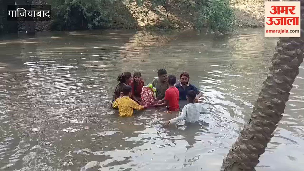 Devotees are immersing Ganesh idols in a temporary pond in Ghaziabad