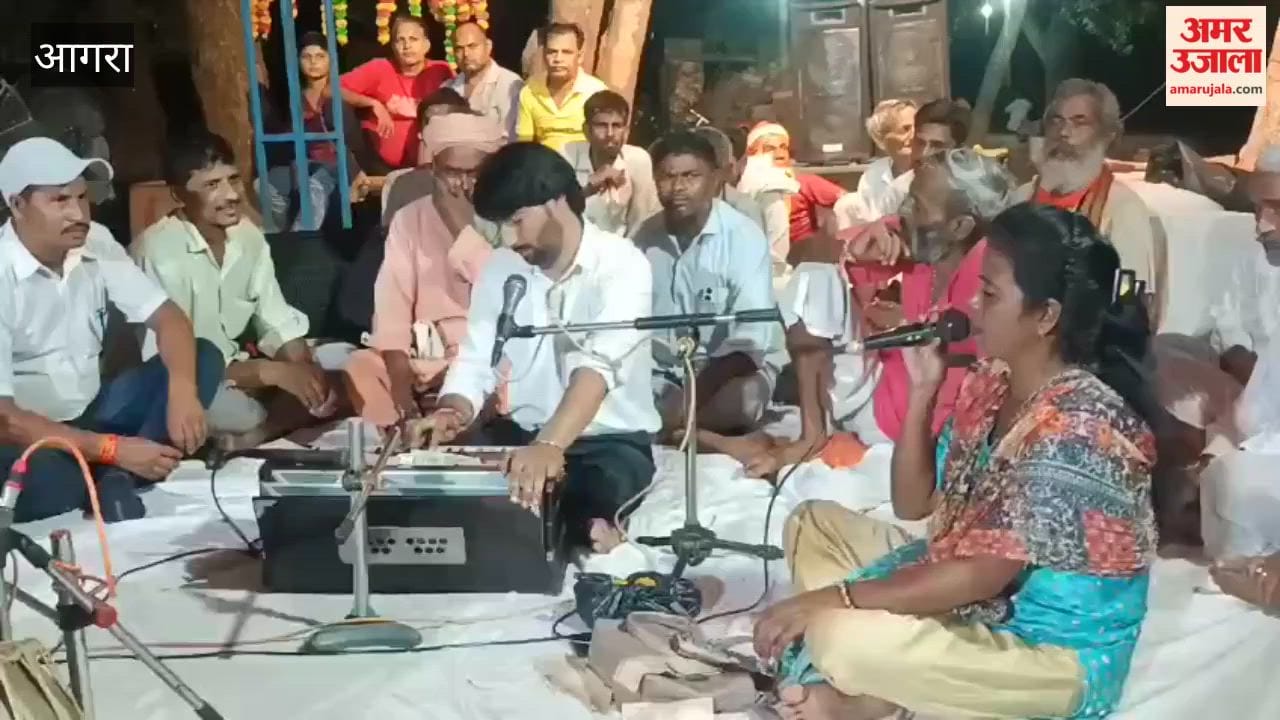 Audience immersed in devotion to Krishna at bhajan evening