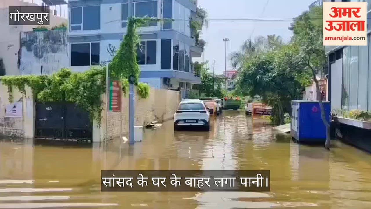 Even after 12 hours, knee-deep waterlogging persists outside MP Ravi Kishan's house.