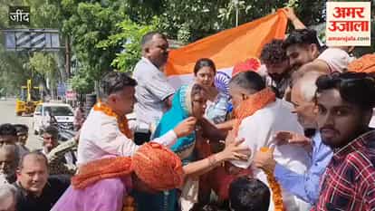 Jind: Welcomed with a mother's affectionate embrace; gold medal draped around grandfather's neck.