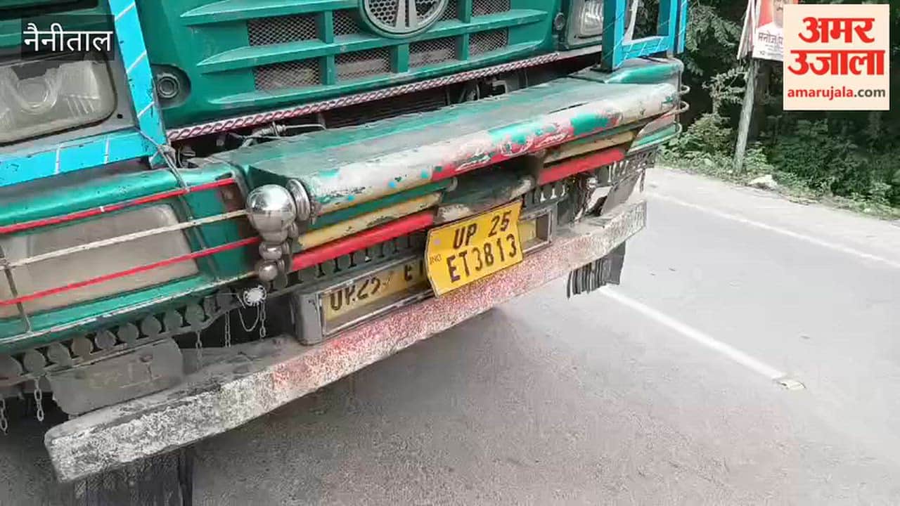 A truck loaded with bricks sinks into the footpath in front of Shakuntalam Banquet Hall in Haldwani.