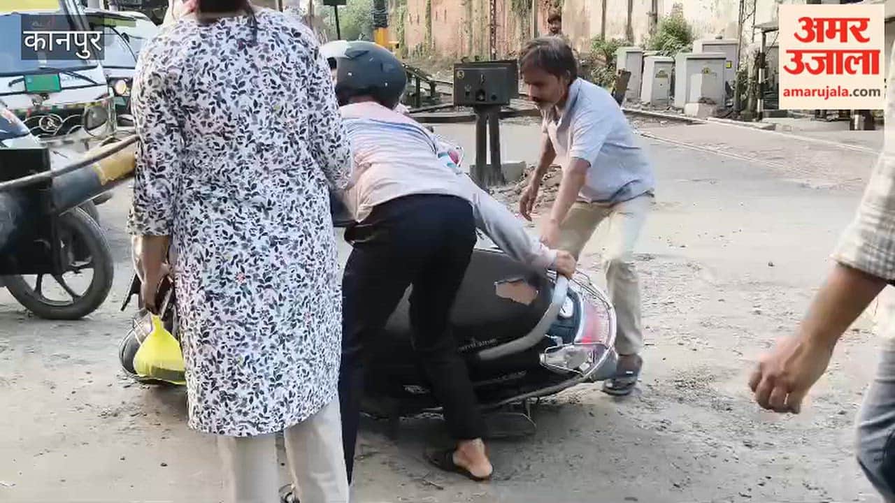 People are risking their lives to cross while the railway crossing gate is closed.