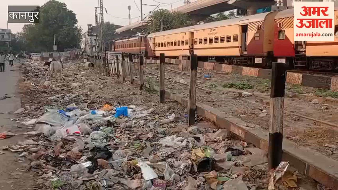 Passengers reach the station by navigating past piles of filth along the railway tracks